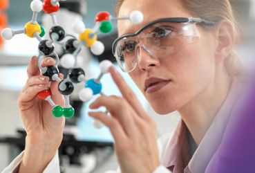 Scientist holding molecular model