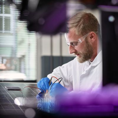 Lab technician soldering a board
