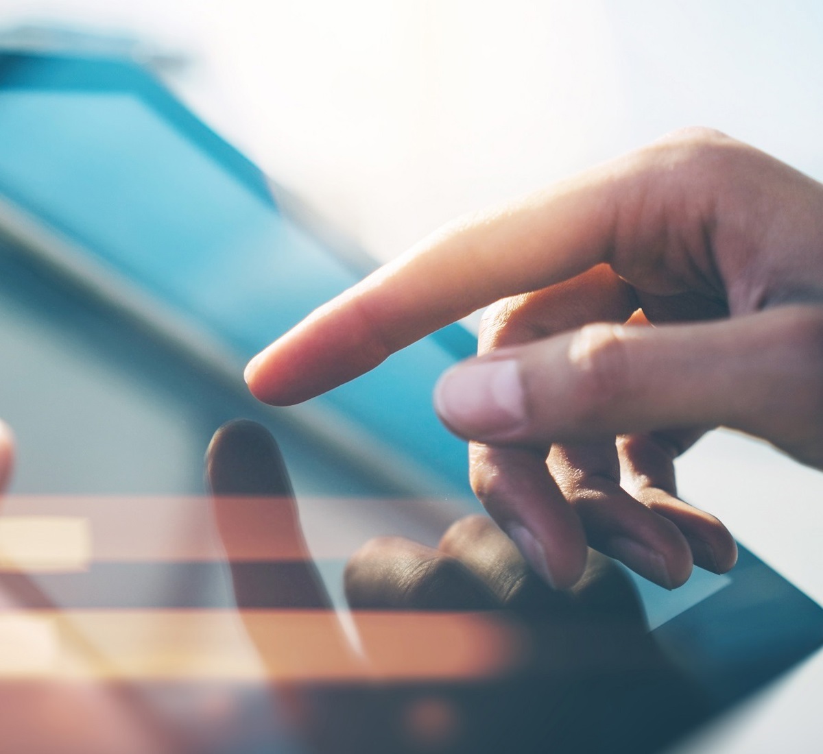 person holding tablet with focus on finger tapping black screen